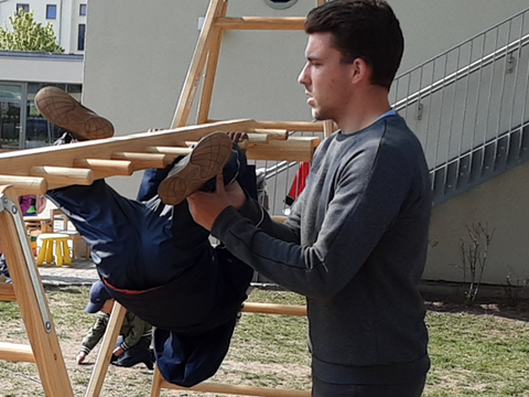 Kopfüber übt ein Kid für eine Akrobatiknummer